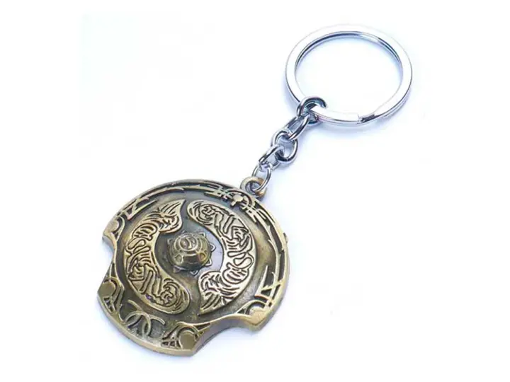 LLAVERO DOTA CHAMPION SHIELD GOLD, COLOR BRONZE, FORMA DE ESCUDO, 2 MOD ( CHAMPION SHIELD GOLD )